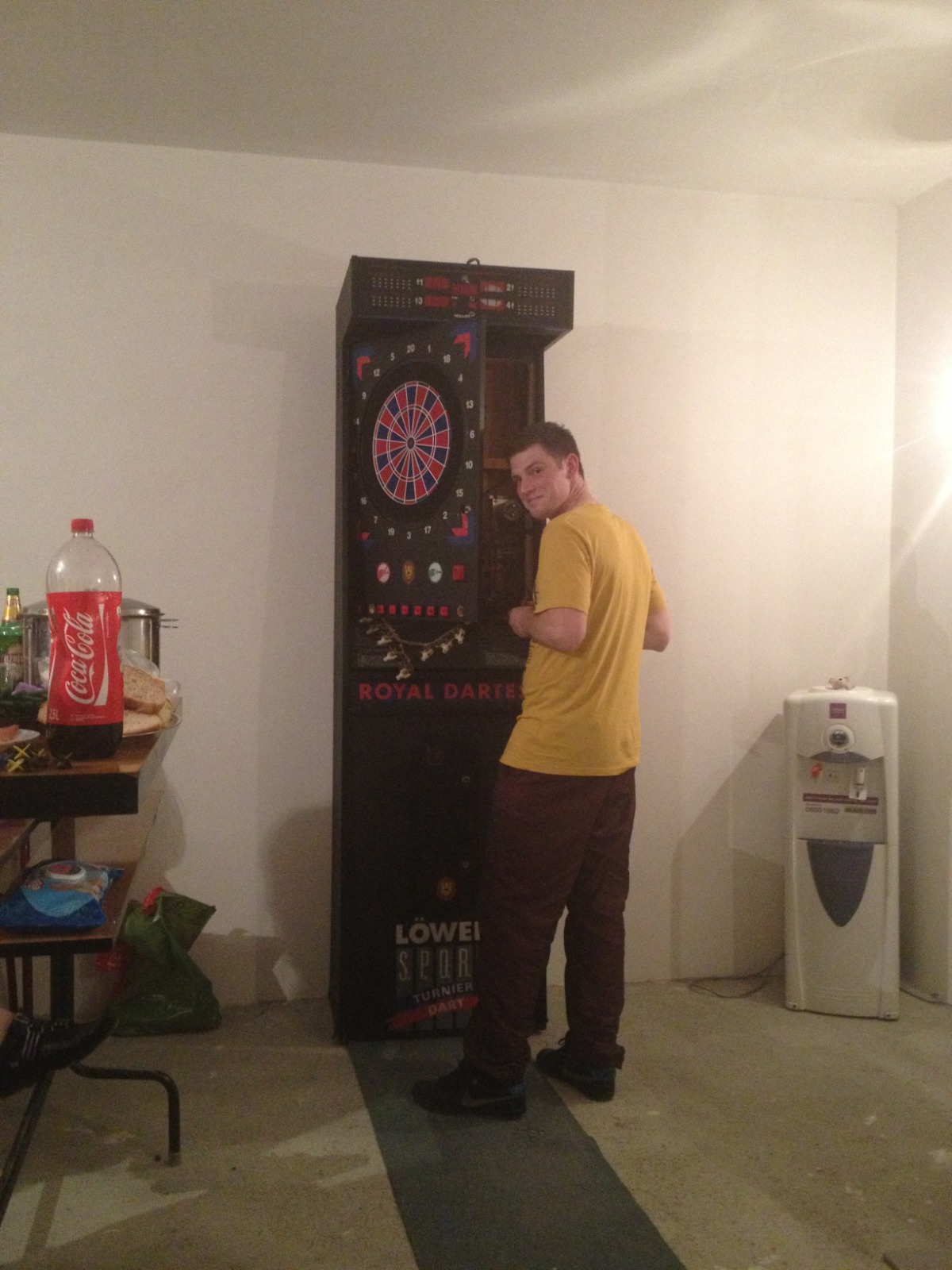 2013 party maintenance on a Löwen FM90 electronic dart machine with the cabinet open during a bulb replacement