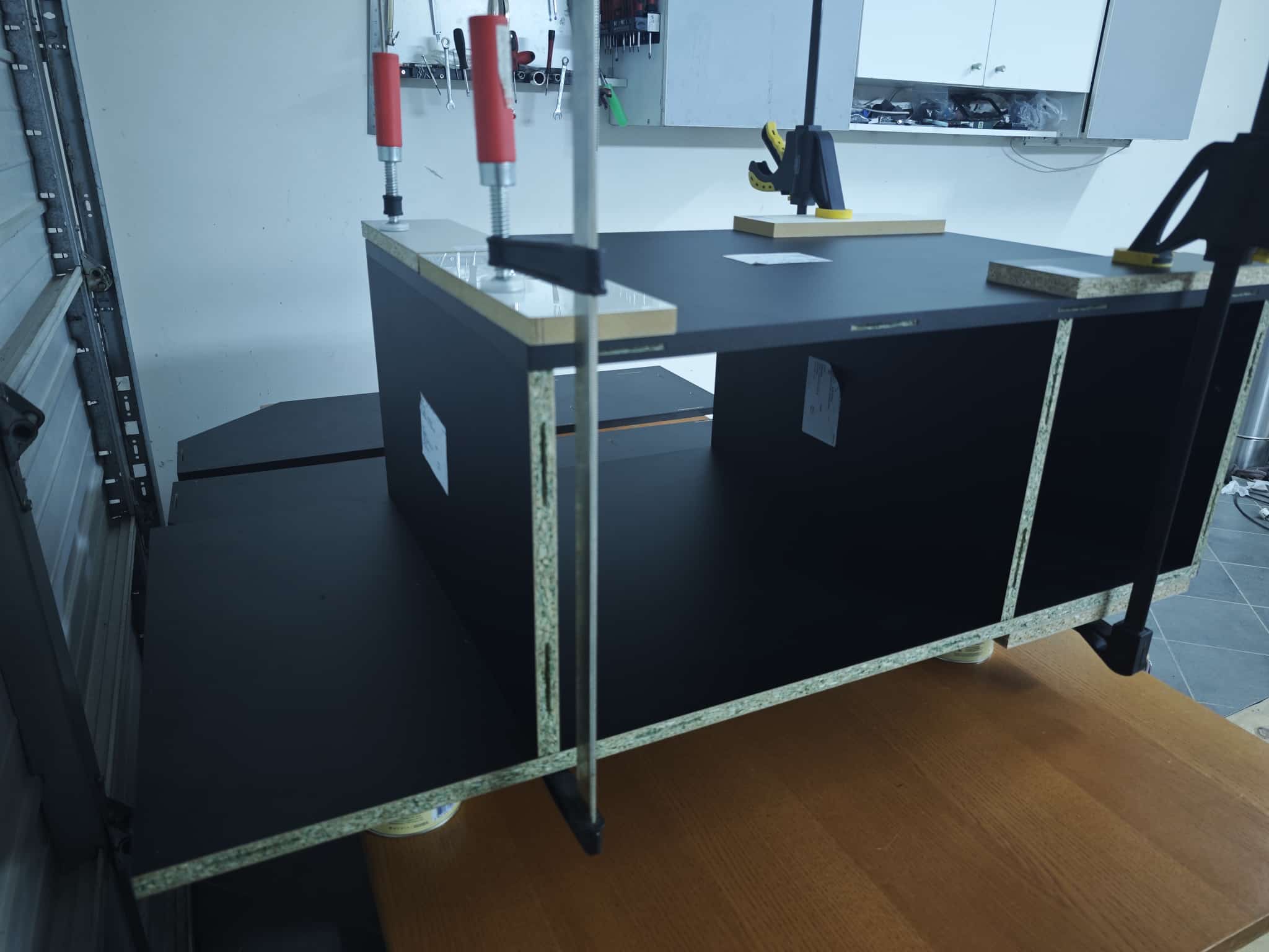 Base section panels for the dartR Vulcano cabinet being assembled in the garage