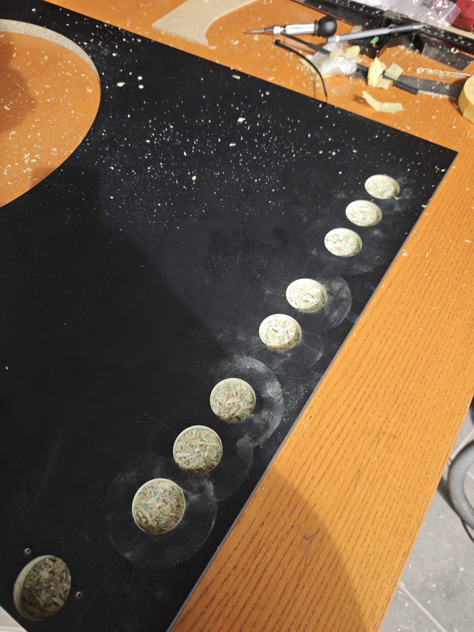 Routed button holes along the edge of the Vulcano dartboard section panel