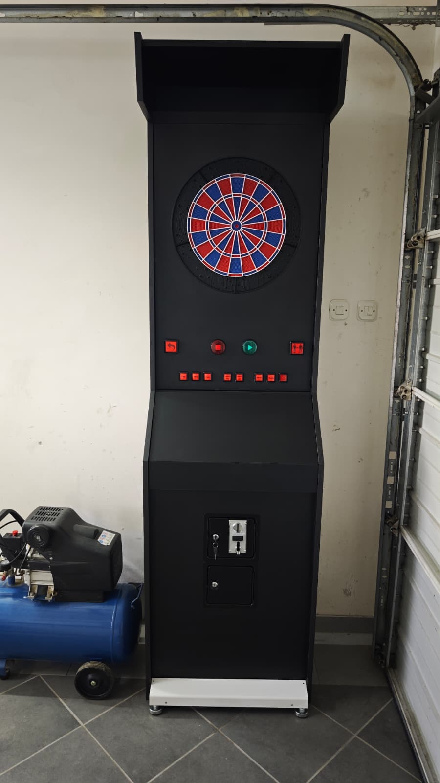 Vulcano cabinet in the garage with the dartboard and arcade buttons fitted