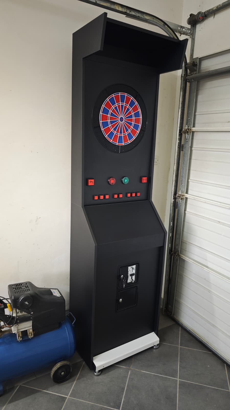 Angled view of the Vulcano cabinet with the dartboard and button row in place